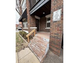 A sign on a brick building states that the premises are under 24 hour video surveillance.