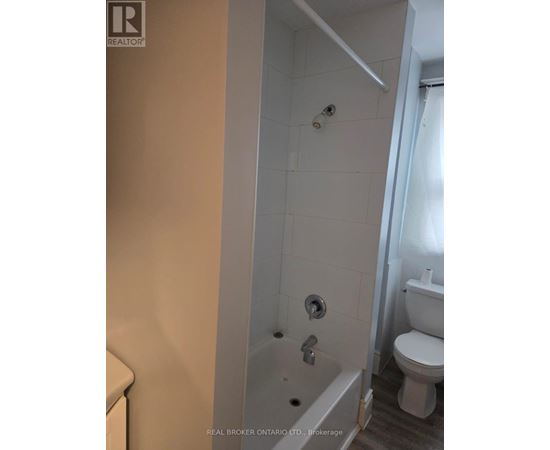 A white toilet is next to a white bathtub in a bathroom.