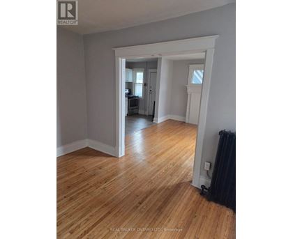 A room with wooden floors and white walls.