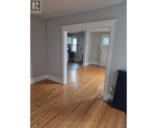 A room with wooden floors and white walls.