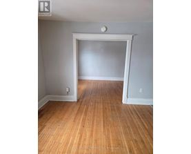 A room with wooden floors and white walls.