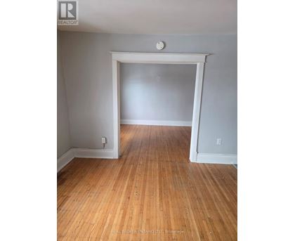 A room with wooden floors and white walls.