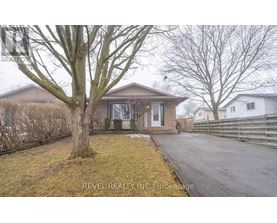 A house with a tree in front of it is for sale.