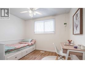 A bedroom with a bed, desk, and chair.