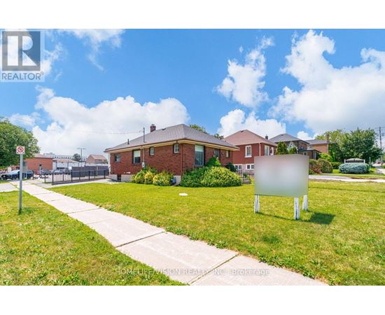 A realtor sign is in front of a house.