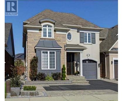 A two-story house with a garage is for sale.