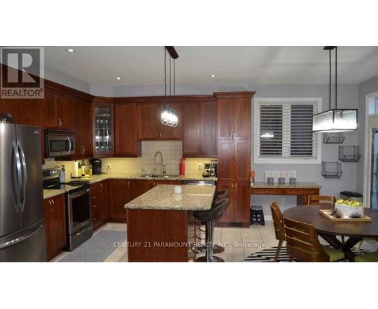 A kitchen with wooden cabinets and a granite countertop.