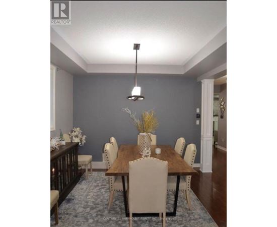 A dining room with a wooden table and chairs.
