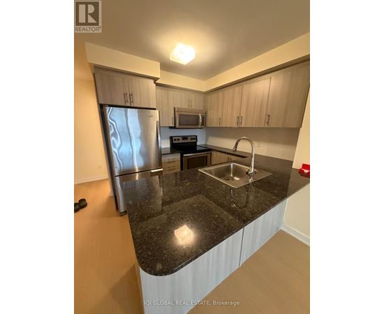 A kitchen with granite countertops and stainless steel appliances.