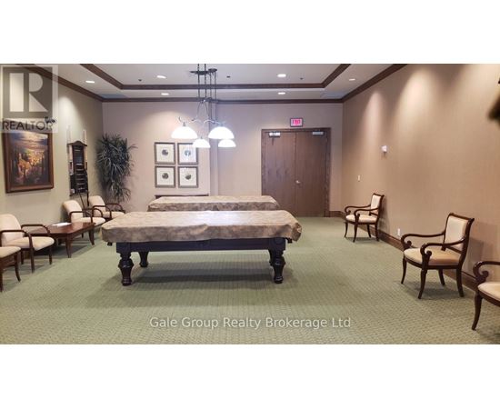 A bedroom with a bed, chairs, and a painting on the wall.