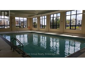 A large indoor swimming pool with a ladder on the side.