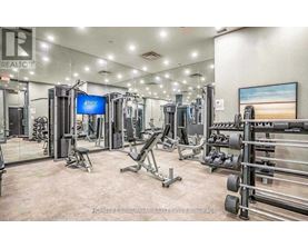A well-equipped gym with various exercise machines and weights.