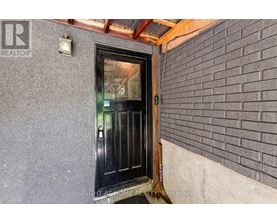 A black door with a glass window is seen in the image.