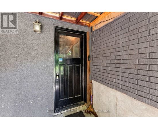 A black door with a glass window is seen in the image.