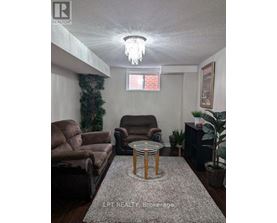 Living room with a couch, chair, and a table.