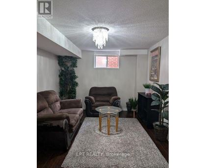 Living room with a couch, chair, and a table.