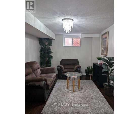Living room with a couch, chair, and a table.