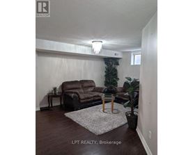 A living room with a brown couch and a small table.