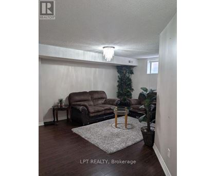 A living room with a brown couch and a small table.