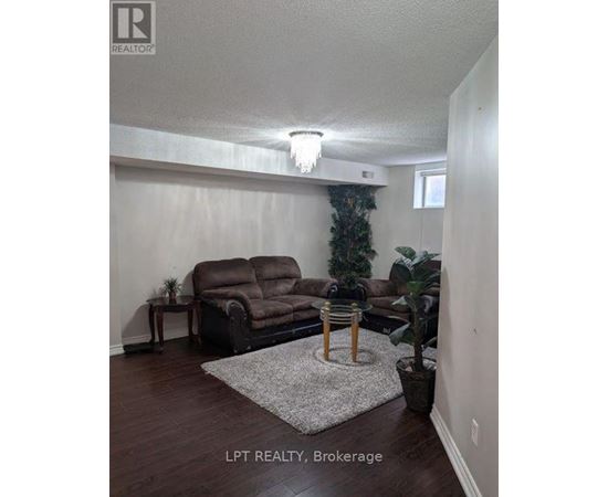 A living room with a brown couch and a small table.