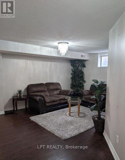A living room with a brown couch and a small table.