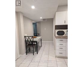 A kitchen with a table and chairs in it.