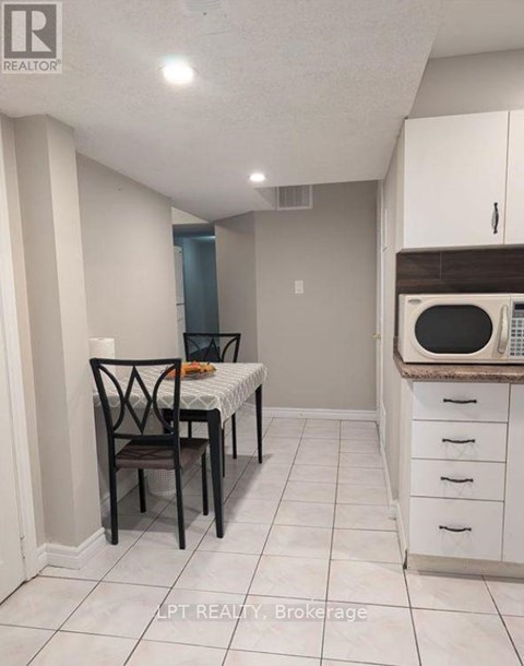 A kitchen with a table and chairs in it.
