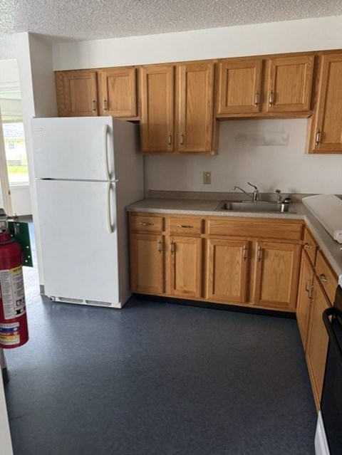 A kitchen with a white refrigerator and wooden cabinets.