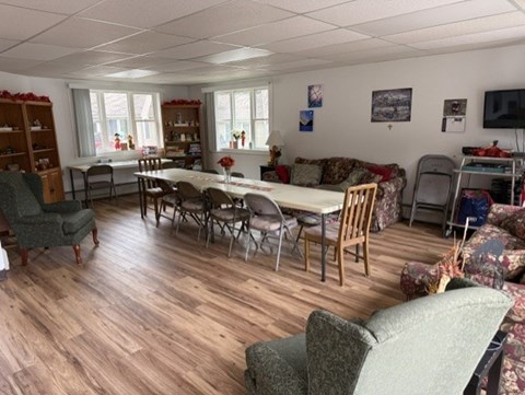 A living room with a dining table and chairs.
