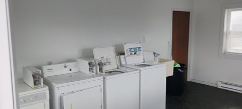 A white washing machine and dryer in a small room.