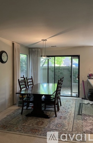 A dining room with a table and chairs.