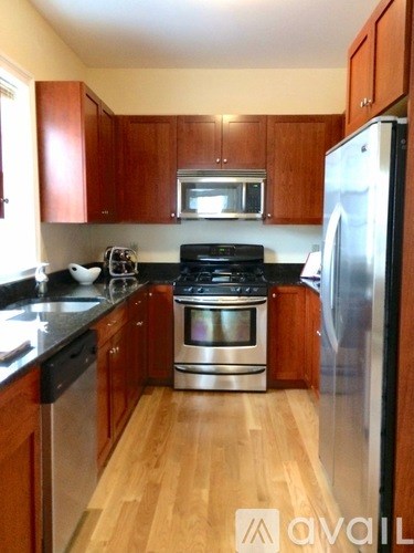 A kitchen with wooden cabinets and stainless steel appliances.