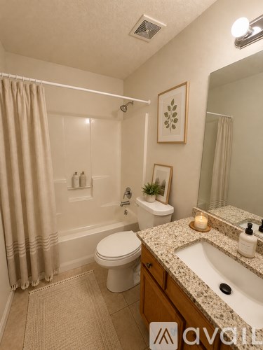 A bathroom with a toilet, sink, and shower.