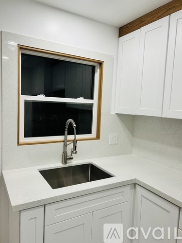 A kitchen with a sink and a window.