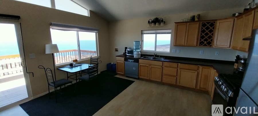 A kitchen with wooden cabinets and a black countertop.