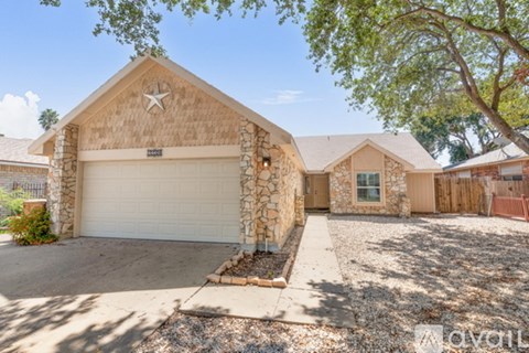 A house with a garage and a driveway in front.
