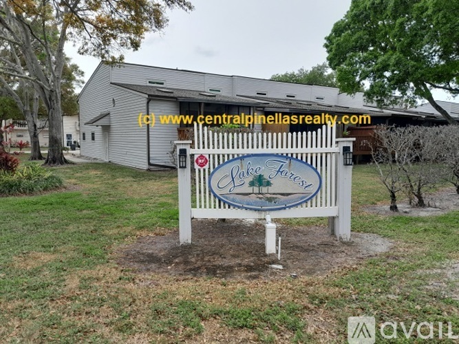 A sign for Lake Forest Estates in front of a building.