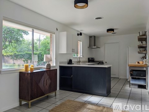 A kitchen with a brown cabinet and a white counter.