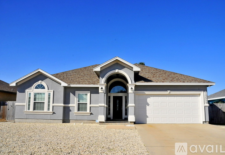 A house with a grey exterior and a white garage door.