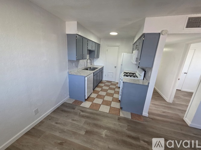 A kitchen with a checkered floor and a sink.