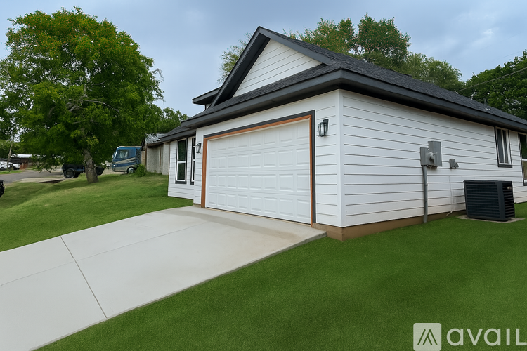 A two-car garage with a white exterior and a brown roof.