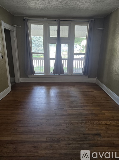 A room with wooden floors and a sliding glass door.
