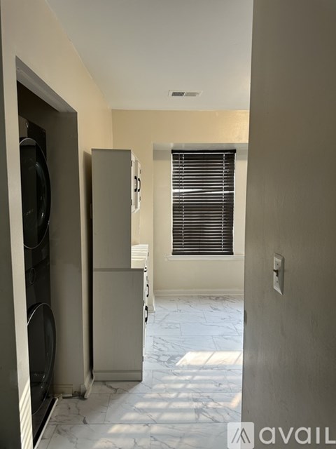 A kitchen with a refrigerator and microwave.