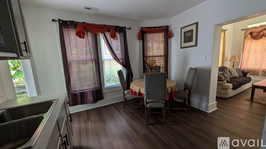 A kitchen with a dining table and chairs is available for rent.