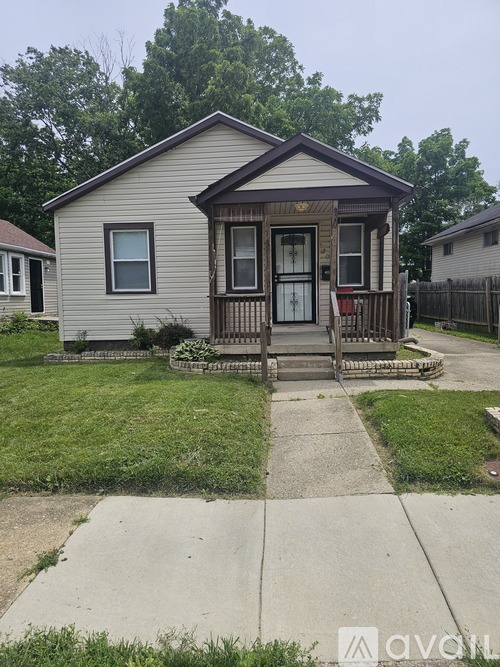 A small house with a brown door and a porch.