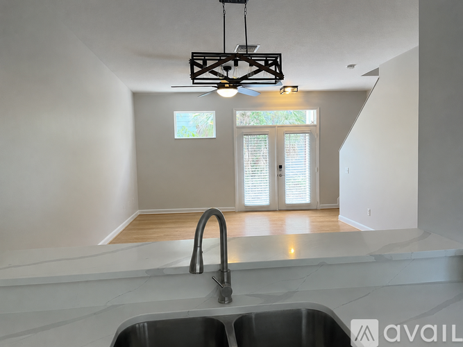 A modern kitchen with a sink and a window.