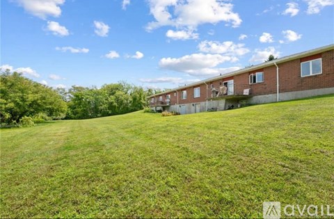 A grassy field with a building in the background.