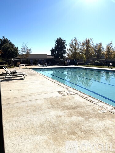 A pool with a sunny sky in the background.