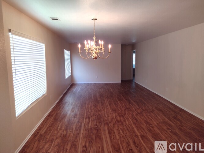 A room with wooden floors and a chandelier.