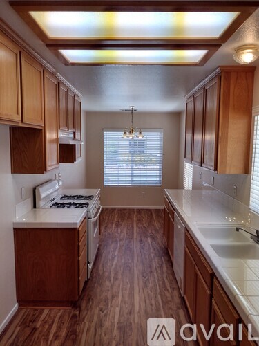 A kitchen with wooden cabinets and a white countertop.